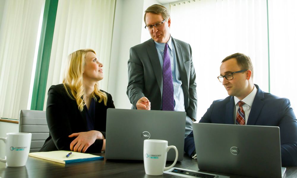 the managing partners of Orndorff Mowen in their office looking at computers