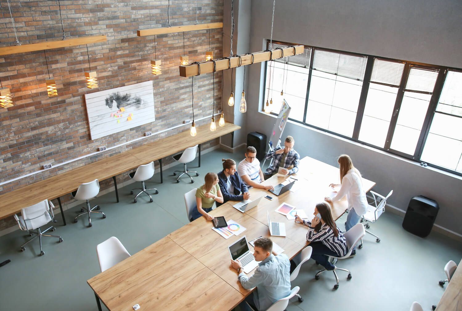 Group of employees working at a conference desk in a modern office