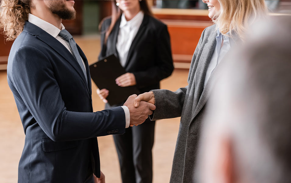 A male and female attorney shaking hands